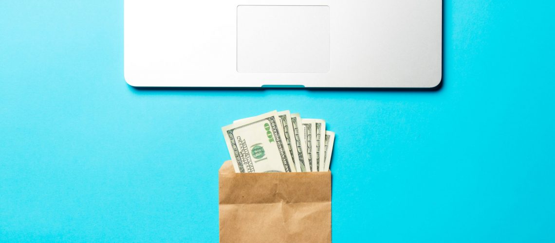 money, envelope and laptop on the blue background