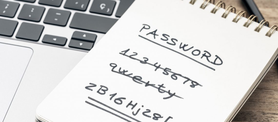 Strong and weak easy Password concept. Handwritten text on notepad on laptop